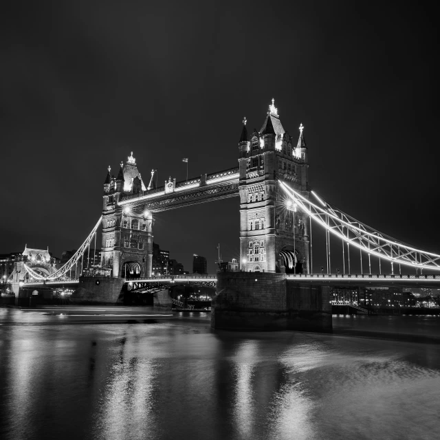 a very tall tower bridge on top of a river