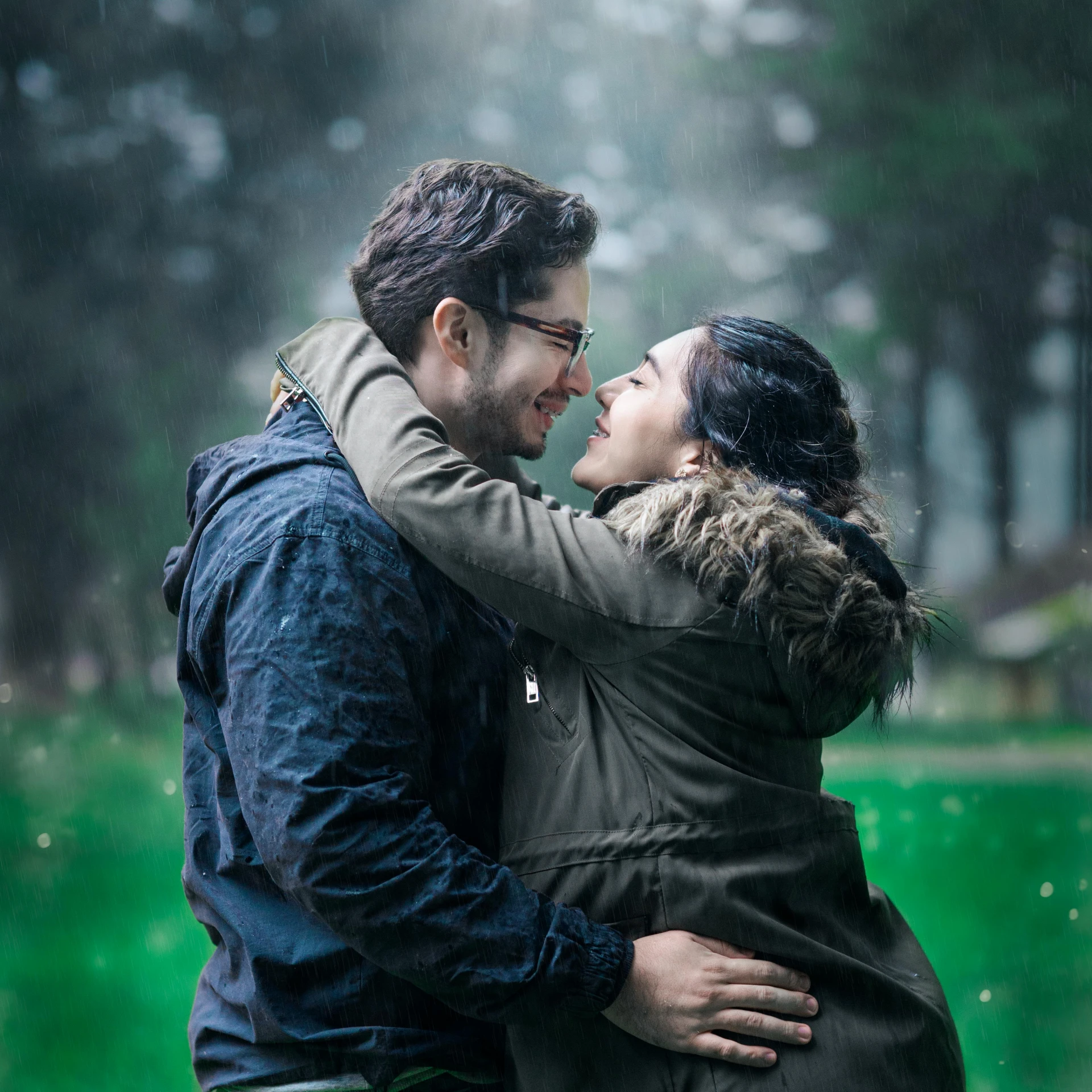 a man and woman emcing each other, with rain falling