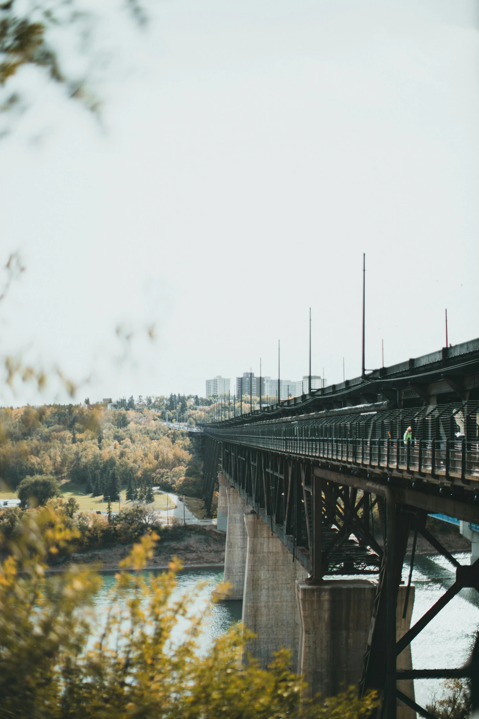 an old bridge over a river with the buildings on both sides