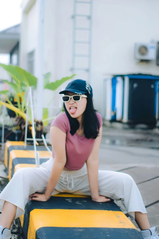 a girl with glasses on a yellow and black box