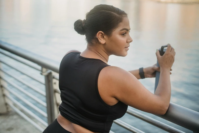 a woman taking a picture of the water from a dock