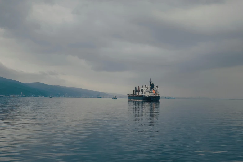 a small boat with people in it sailing in a large body of water