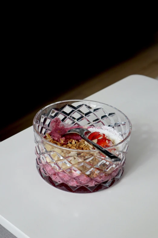 small glass bowl with various foods in it