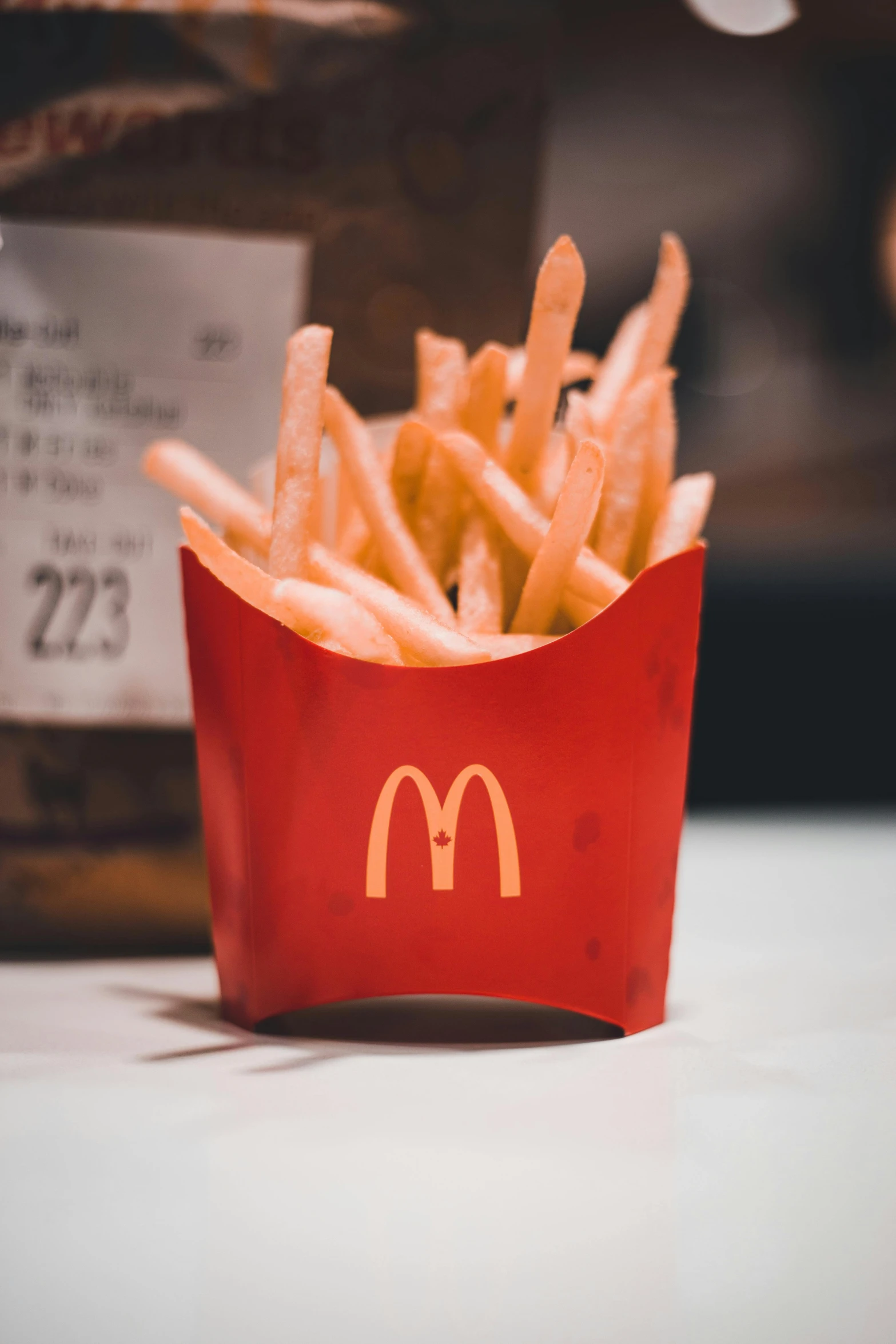 a fast food burger with french fries in a red basket