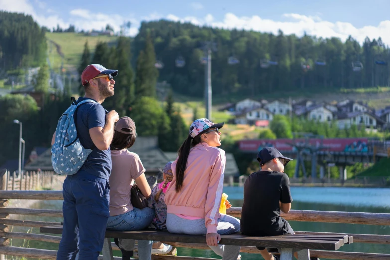 a group of people sit on top of a bench