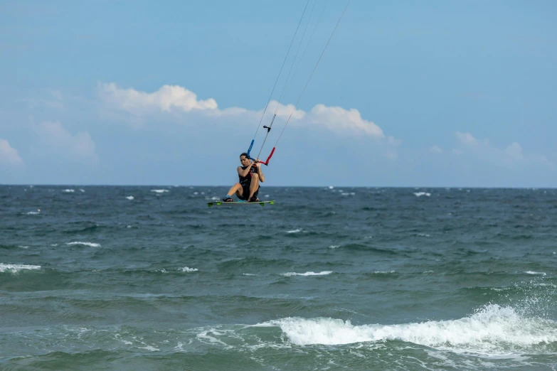 a man riding on the back of a surfboard