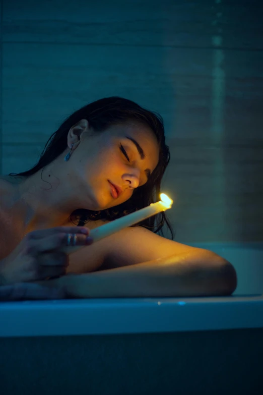 a woman is taking a bath with the candles