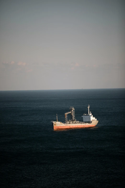 a ship out in the ocean is moving through