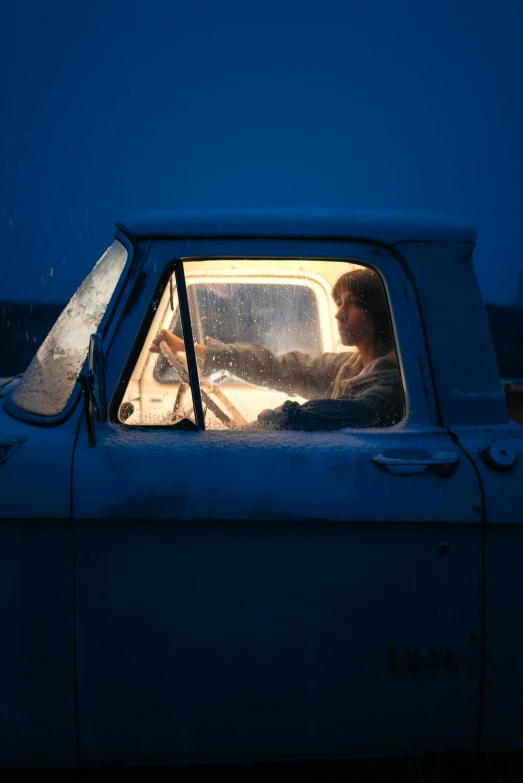 an old man driving on the road during the winter