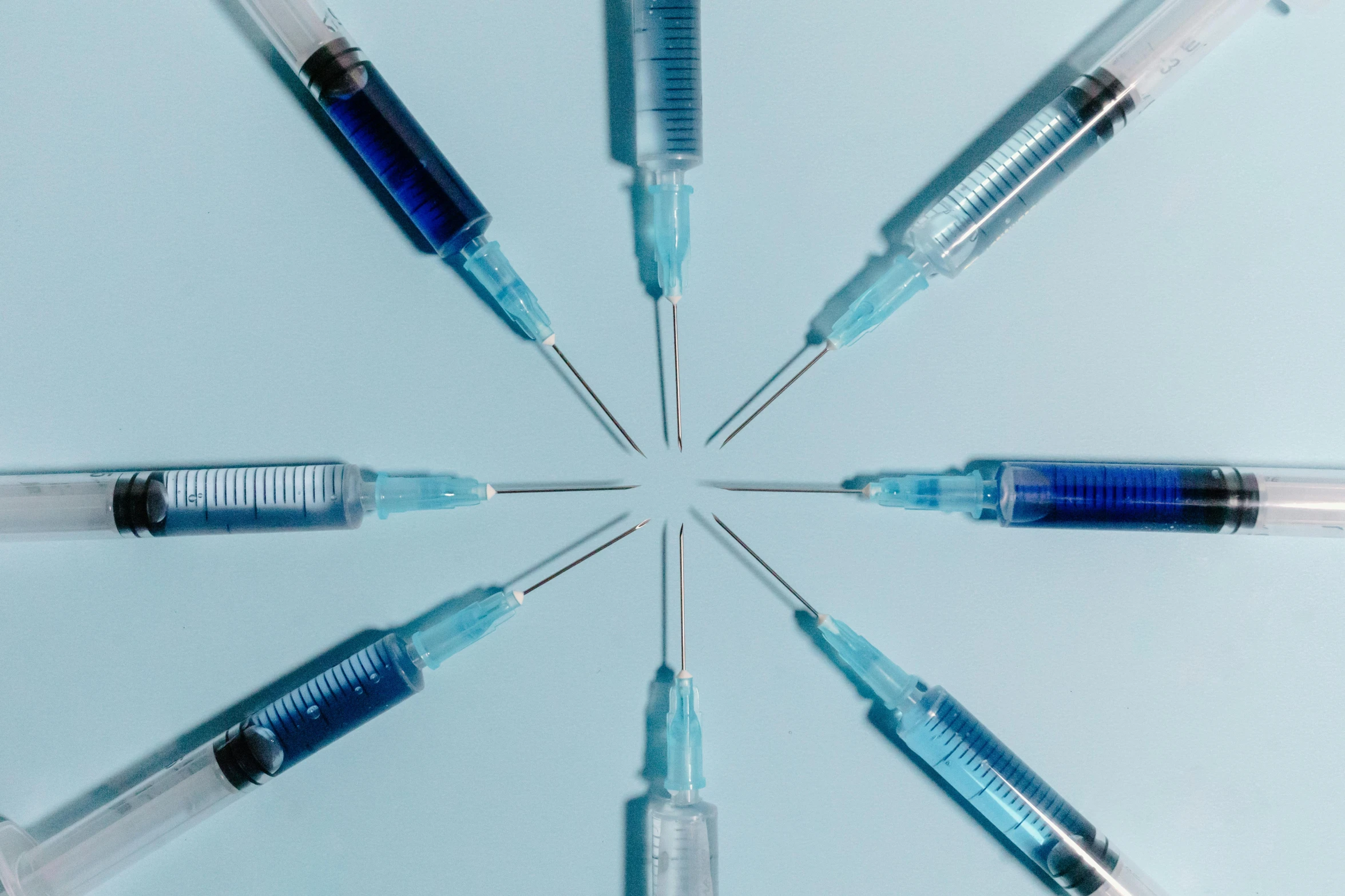 five syses sticking out of an umbrella made of four blue and clear vials