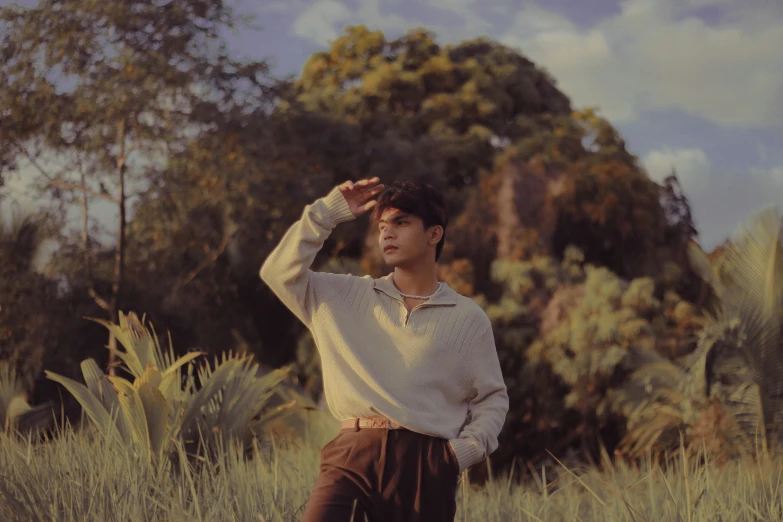 a man standing in tall grass by himself