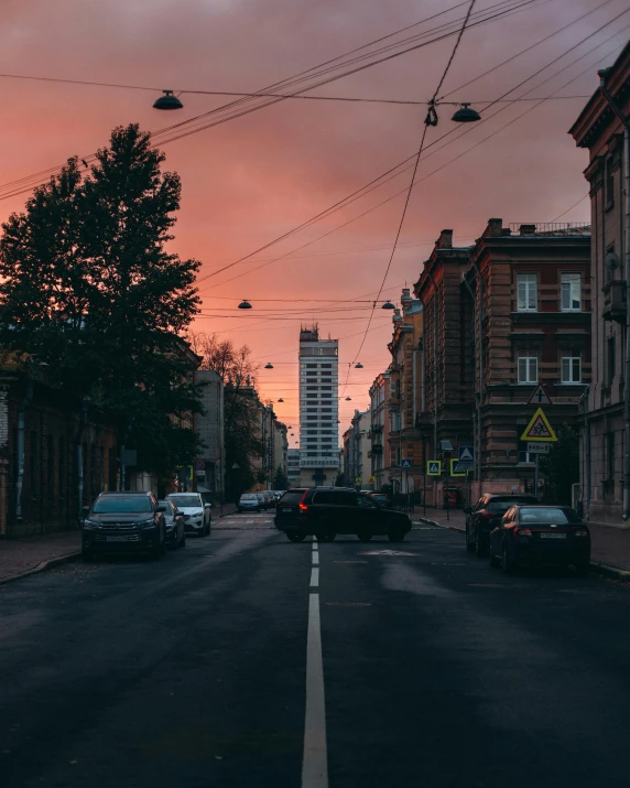 sunset over the street near buildings and cars