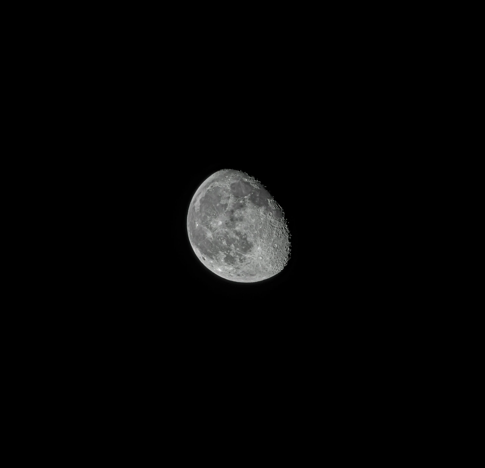 a half moon shining in the dark sky