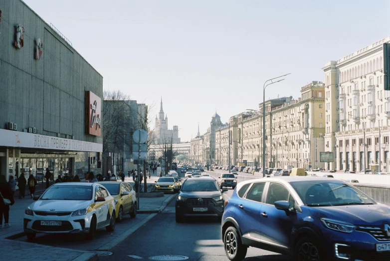 cars parked on a city street in front of some buildings