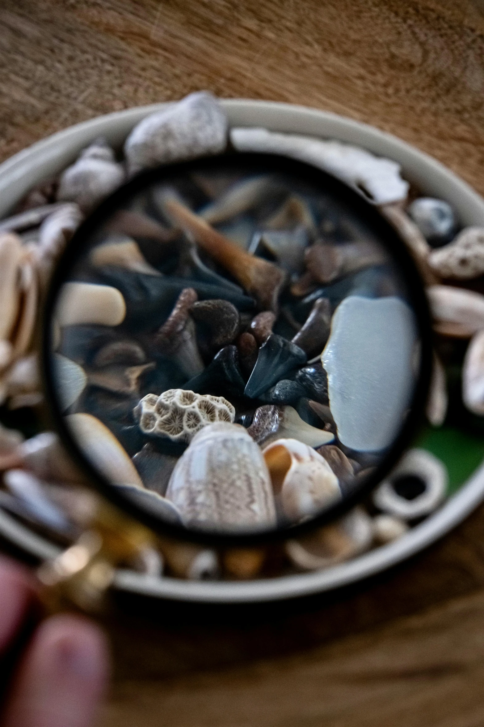 a magnifying glass sits on a wooden surface