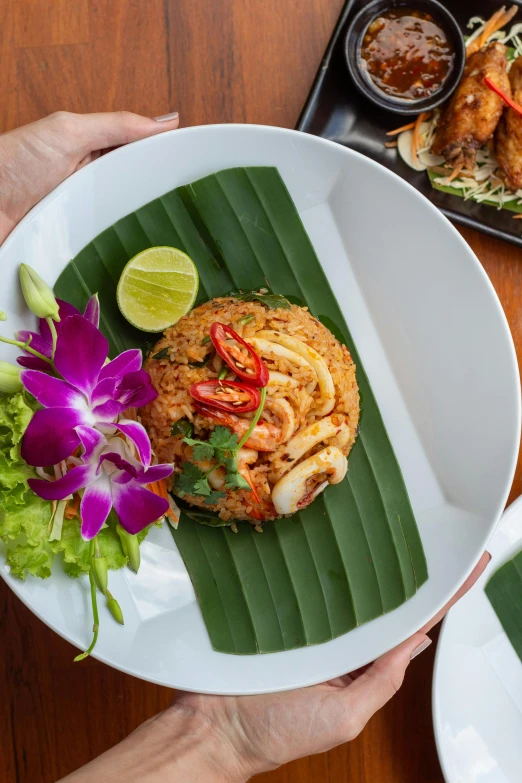 plate of food with shrimp and thai style rice on leaf