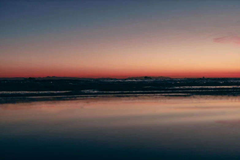 the reflection of a city and a body of water is seen