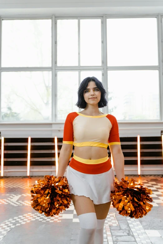 the cheerleader is posing with her team colors