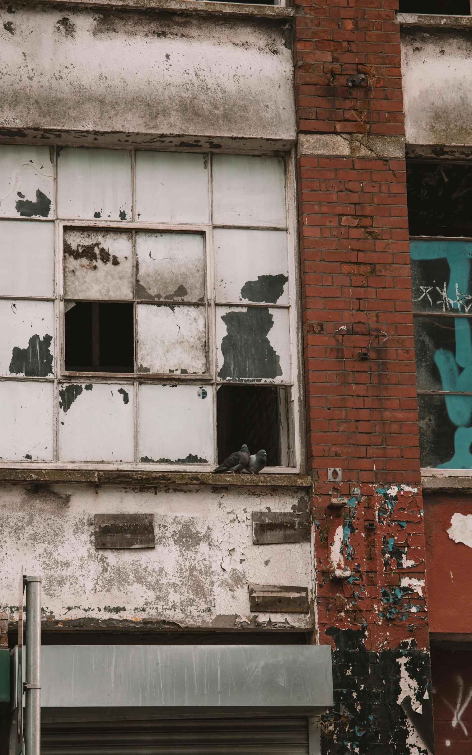 an old, faded building with a broken window