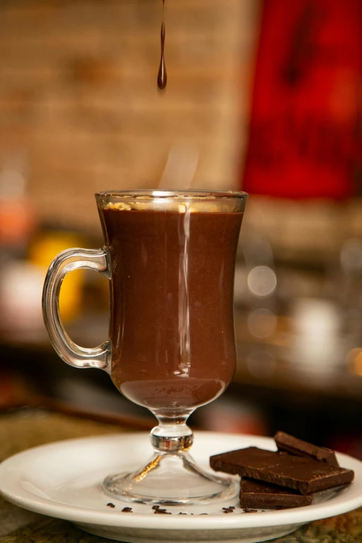 the chocolate is being poured into the mug