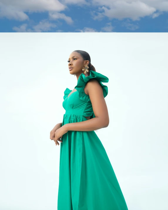 a woman standing in front of a blue sky