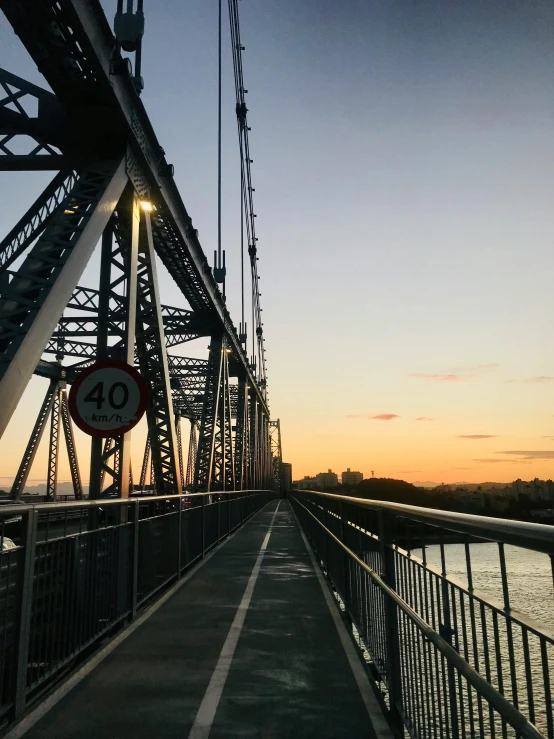 a bridge with no cars is lit up at dusk