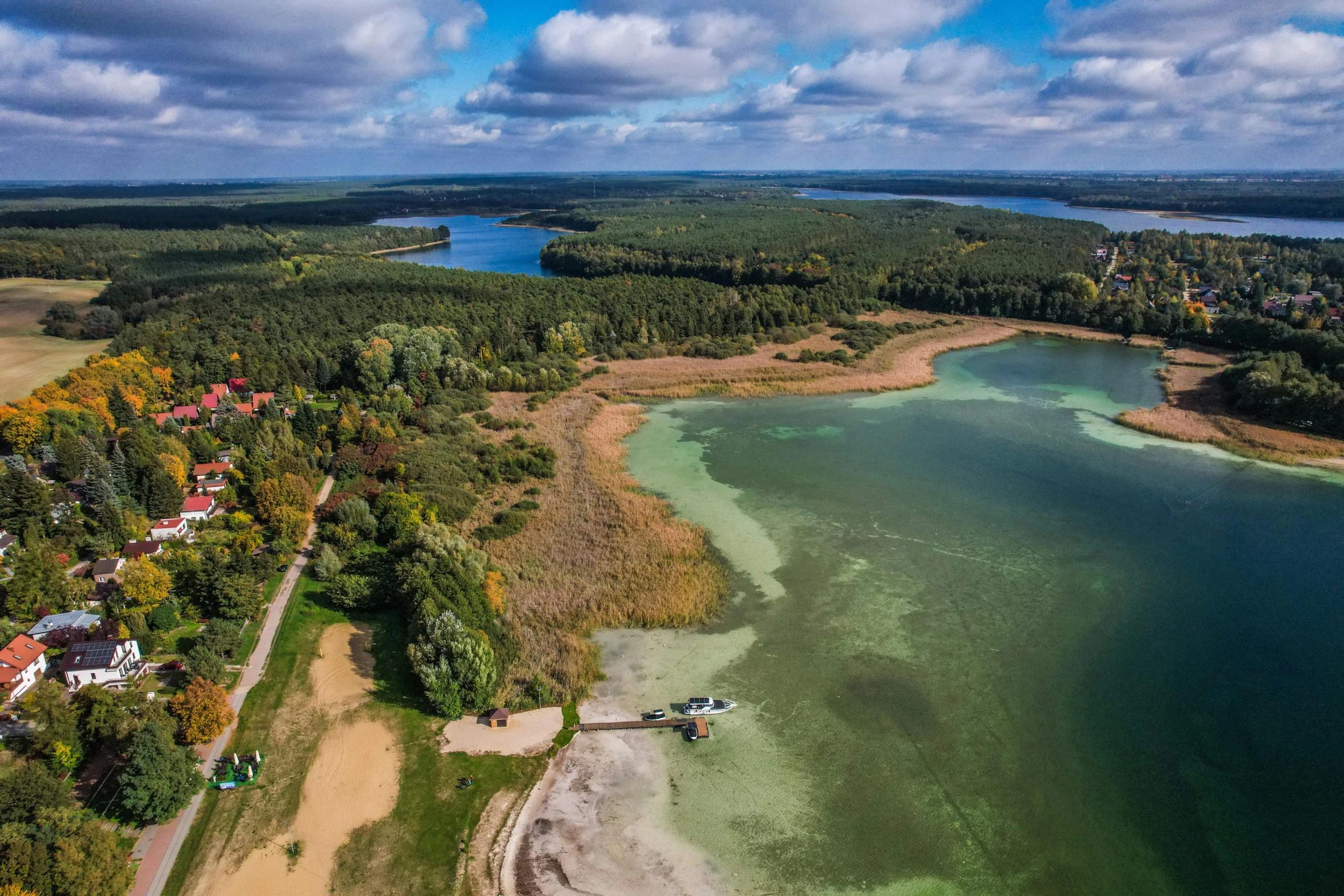 an aerial view of the water, beach and land