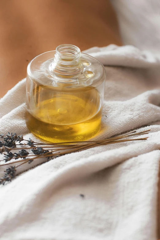 the small bottle of lavender oil on the cloth