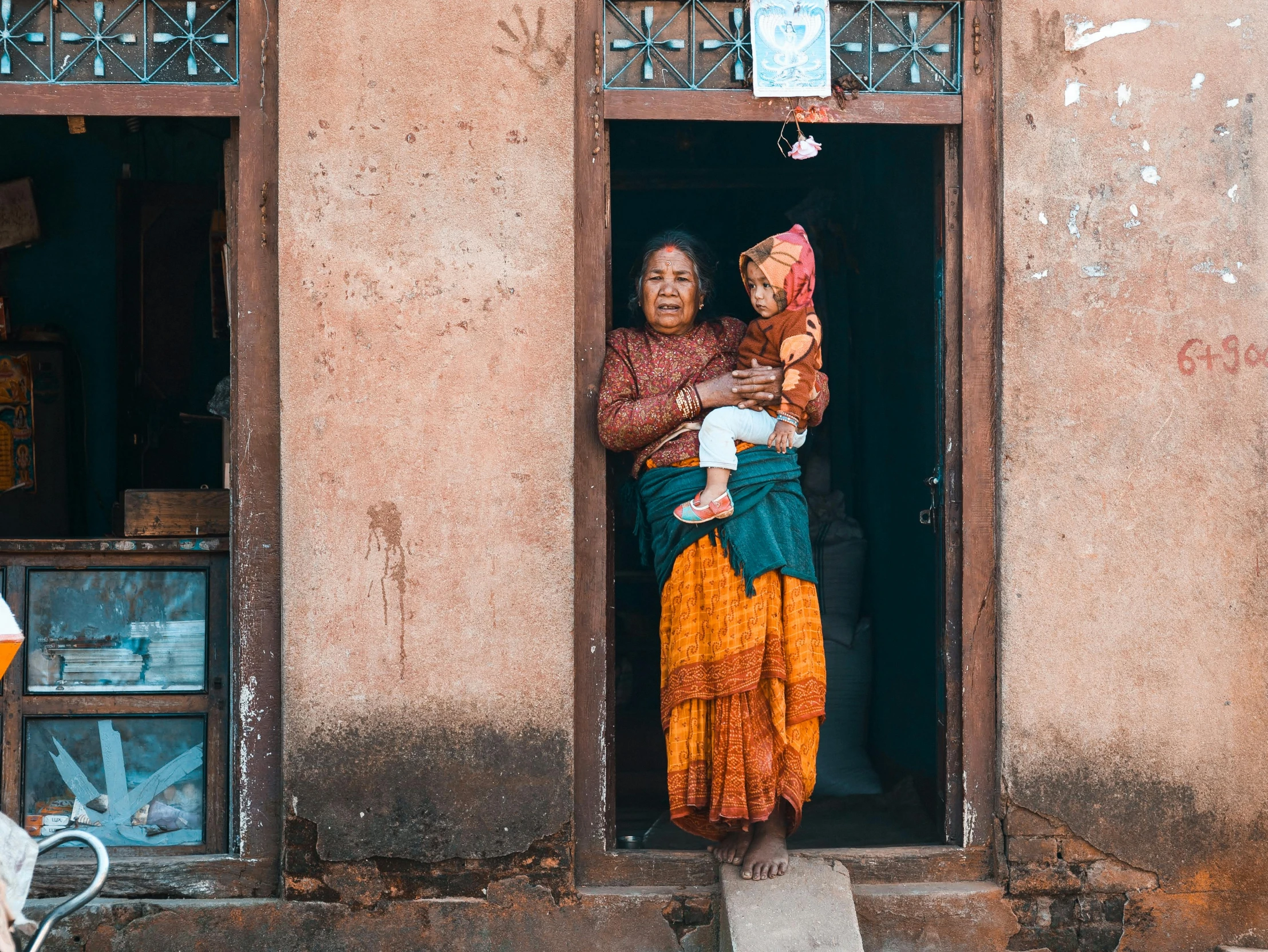 two women standing outside of an apartment building