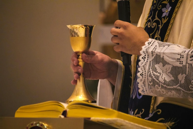 the person is holding a candle during the ceremony