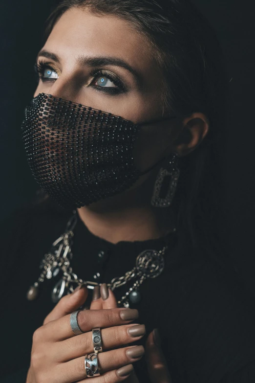 woman wearing silver rings, face and chain