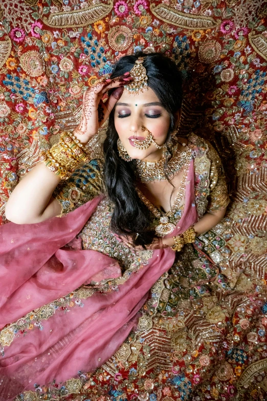 an image of woman with jewelry on her face laying on a bed