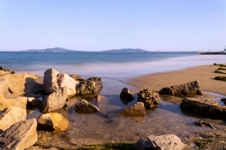 rocks are in the water and shore line