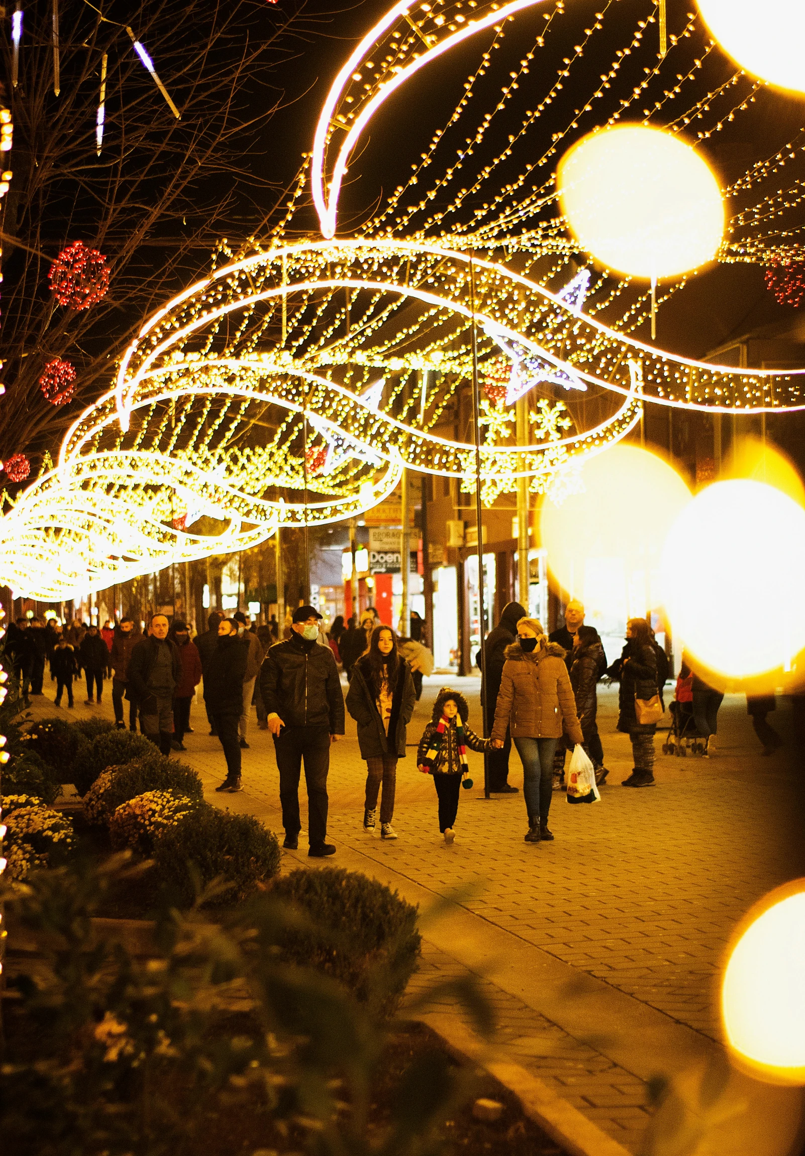 the crowd of people is lit up and walking in the dark