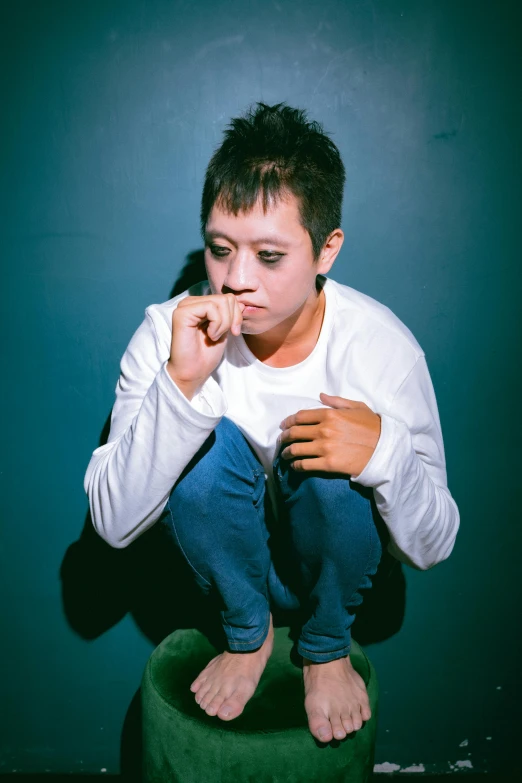 a woman on a stool with her finger to her lips