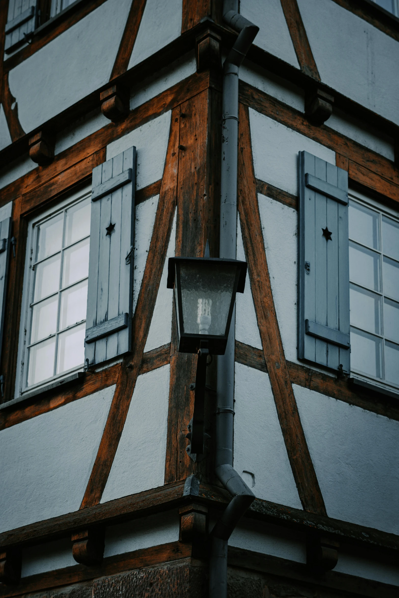 a close up view of a lit lamp in front of a house