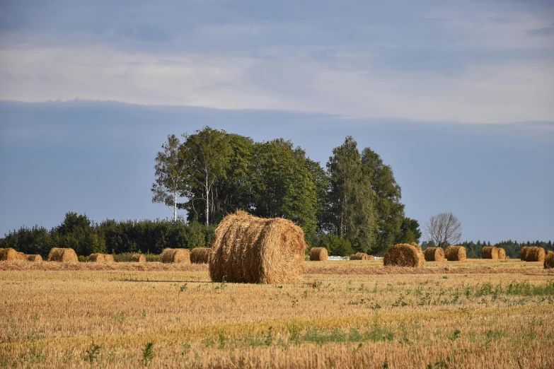 several hay bales are stacked up in the middle of a field