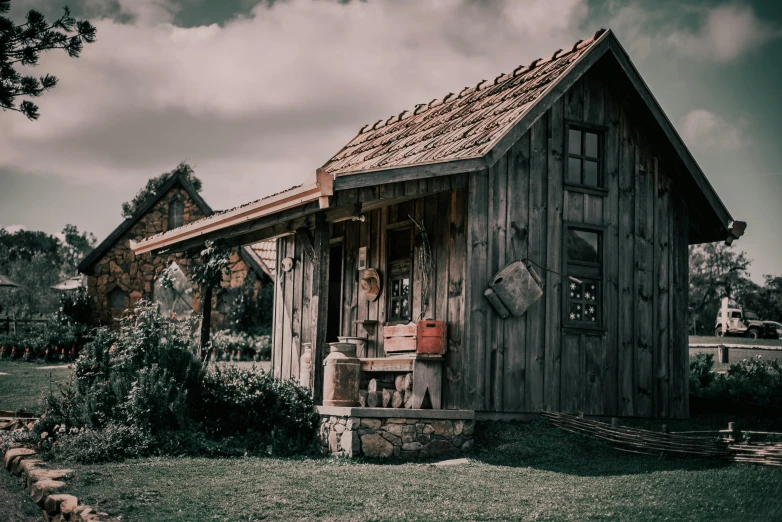 old wooden shack sitting on a farm with lots of grass