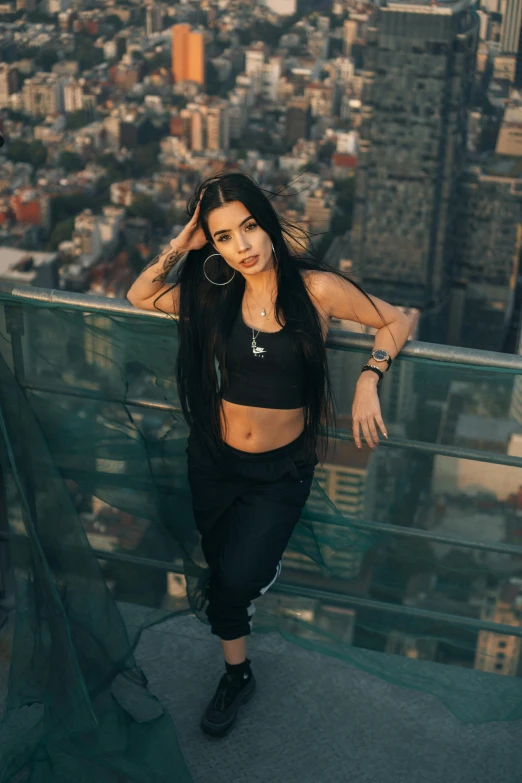 a woman standing on top of a building