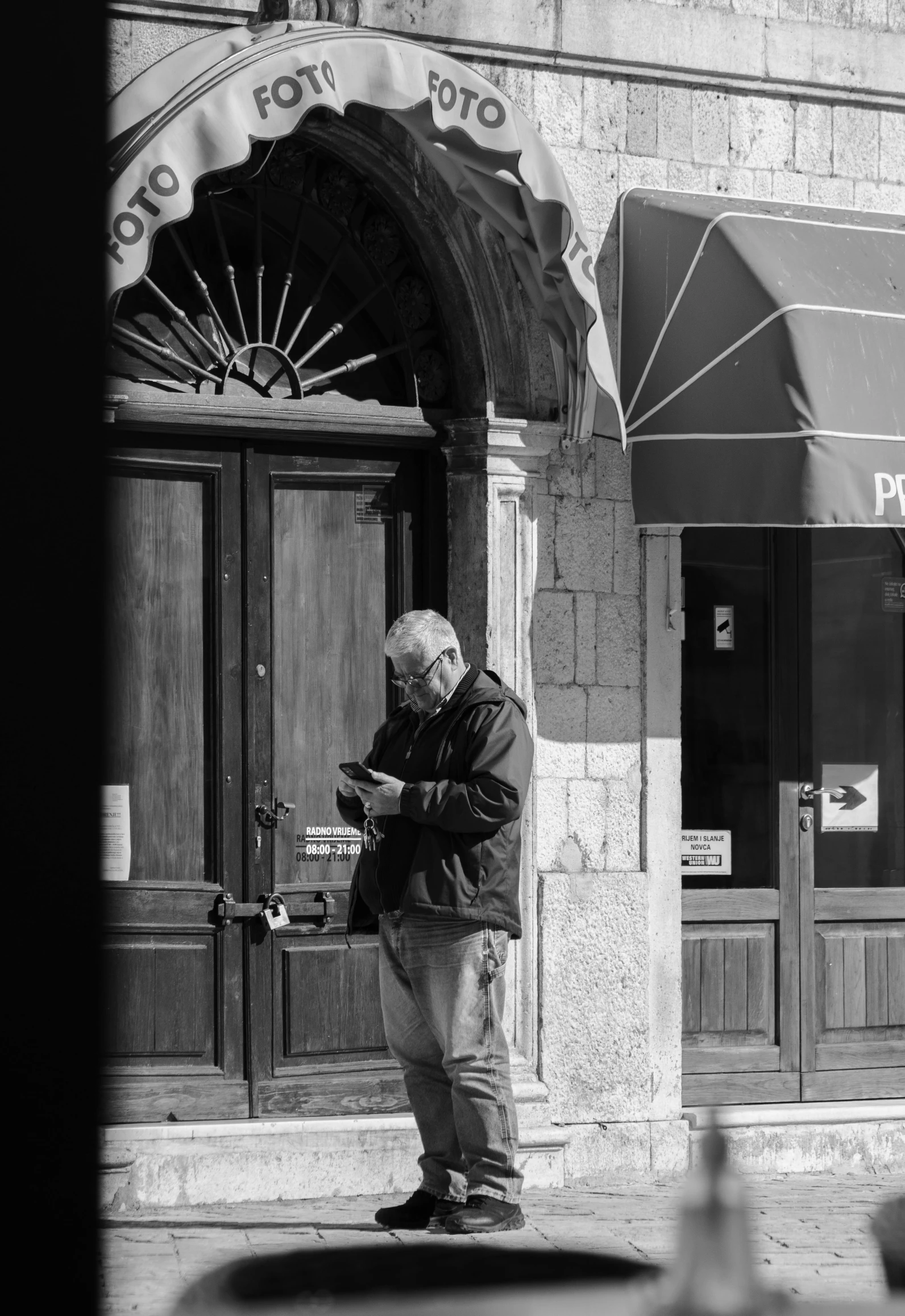 an older gentleman is looking at his cell phone