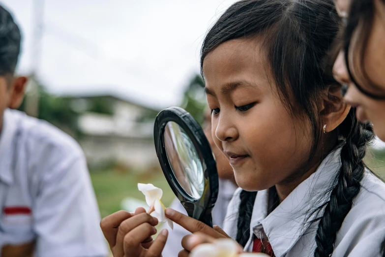 three s looking at the food under a magnifying glass