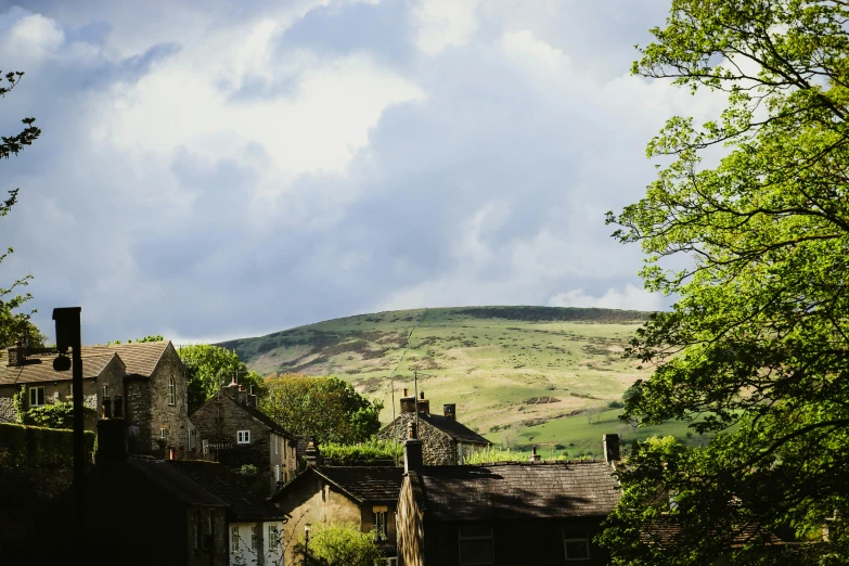 view of several old building with a hillside in the background