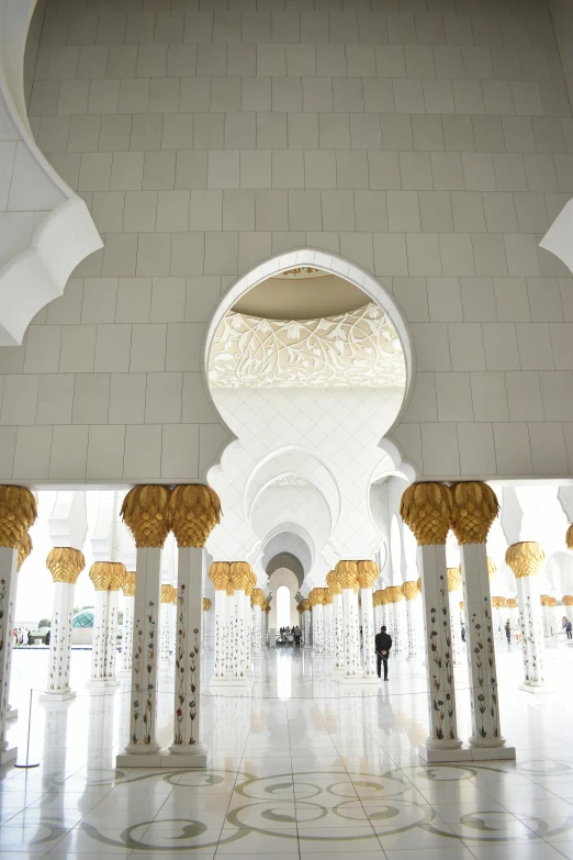 the inside of a building with pillars and lamps