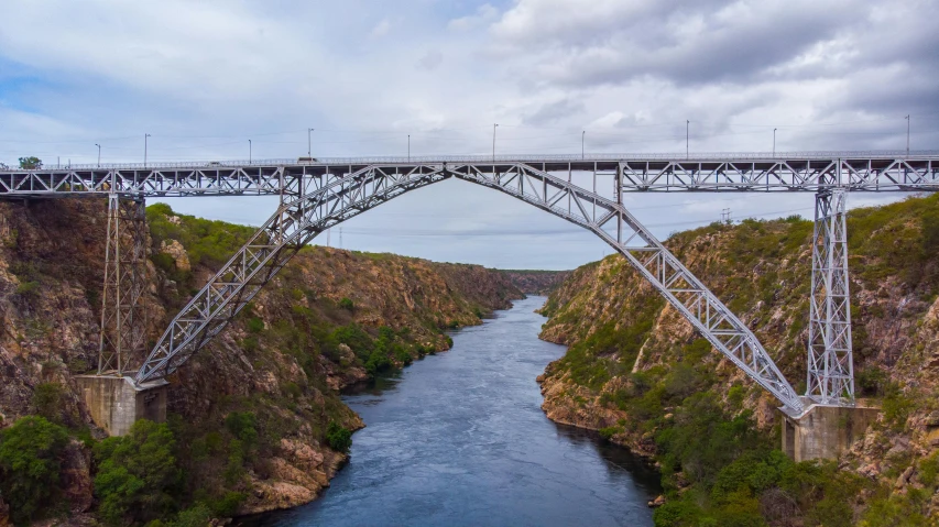 an aerial view of a bridge going over a canyon