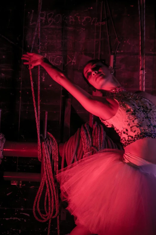 a ballet dancer in a red lit room