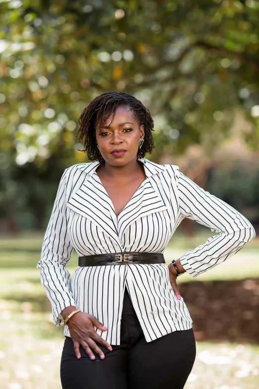 a woman wearing black pants and a white top