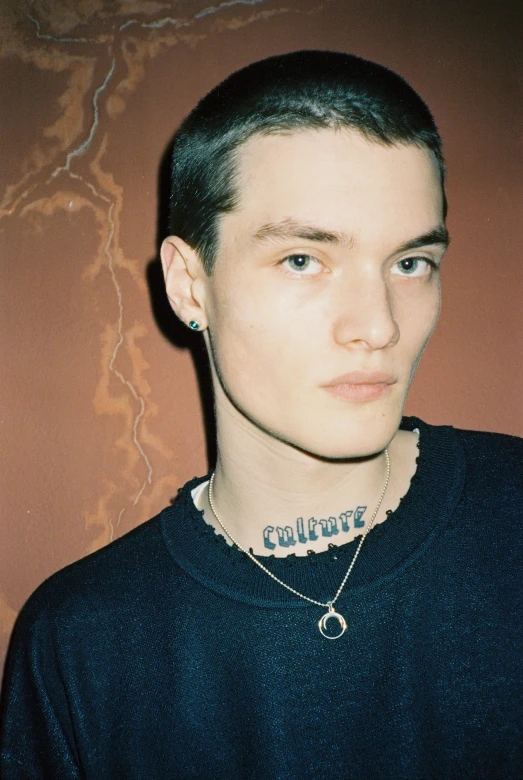 man with piercings in his hair wearing a choker