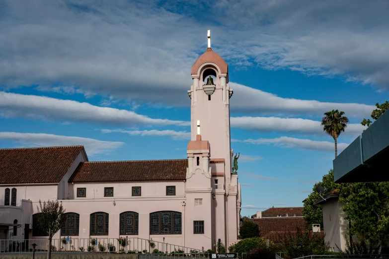 a pink clock tower at a very nice home