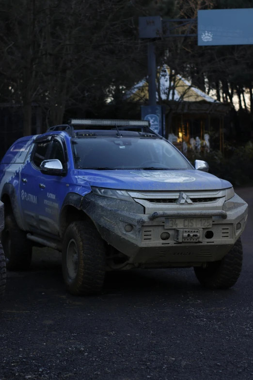 an suv in the street has snow on it