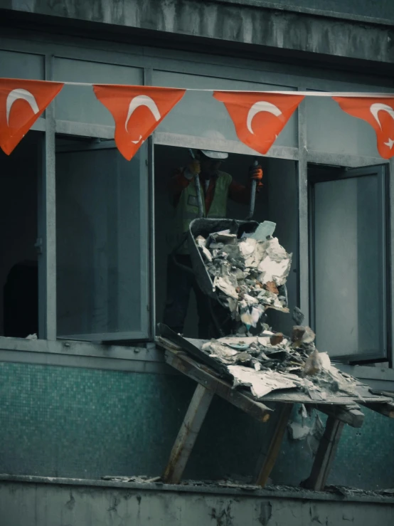 a destroyed up window next to a trash pile